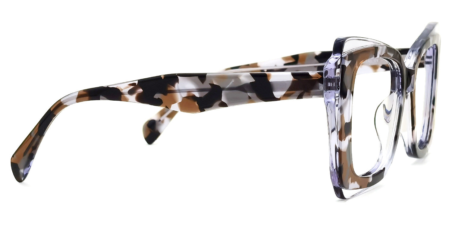 Lentes graduados tipo ojo de gato oversized en acetato translúcido marmoleado en tonos blanco, café y negro. Diseño moderno con efecto carey contemporáneo, ideal para un estilo elegante y vanguardista.