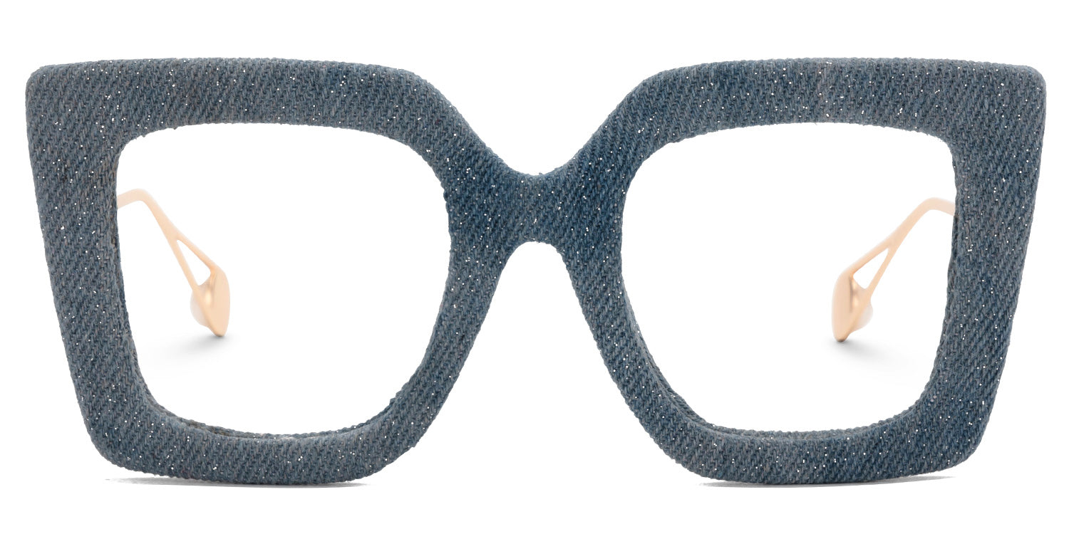 Lentes graduados cuadrados oversized con acabado tipo mezclilla azul y varillas metálicas doradas. Diseño exclusivo que combina textura textil, sofisticación y estilo contemporáneo.