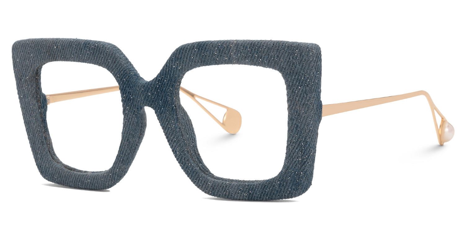 Lentes graduados cuadrados oversized con acabado tipo mezclilla azul y varillas metálicas doradas. Diseño exclusivo que combina textura textil, sofisticación y estilo contemporáneo.