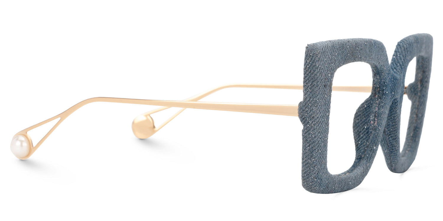 Lentes graduados cuadrados oversized con acabado tipo mezclilla azul y varillas metálicas doradas. Diseño exclusivo que combina textura textil, sofisticación y estilo contemporáneo.